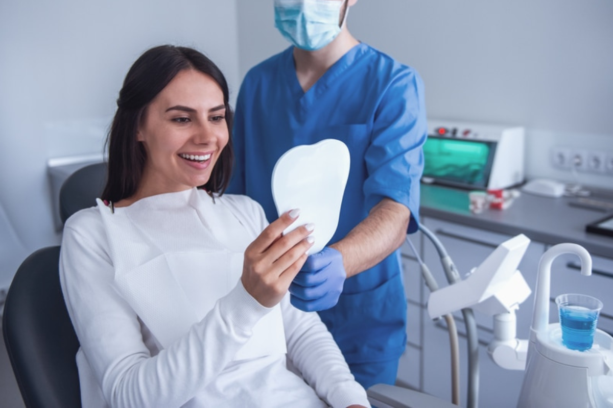Female patient examining dental model with dentist in Lake Ridge dental office.