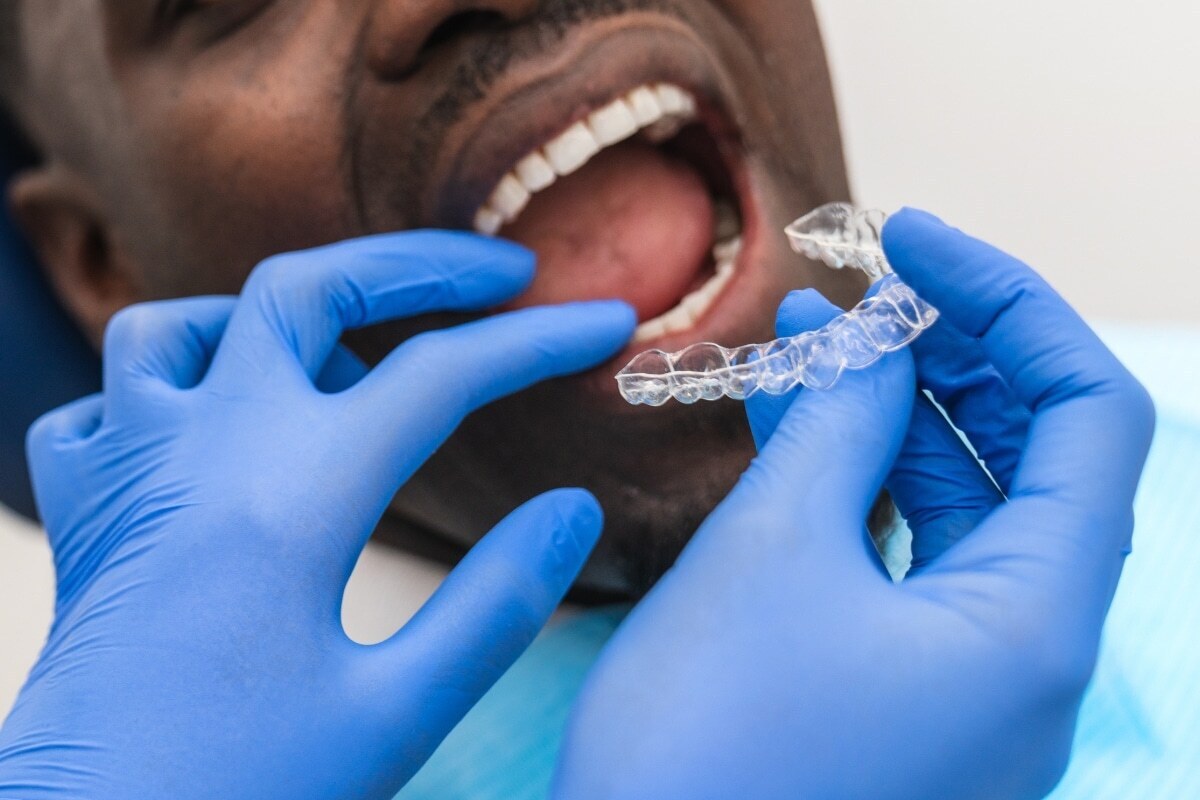 Dentist holding clear Invisalign aligner tray during Lake Ridge orthodontic consultation.