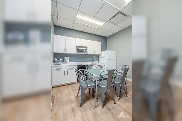Pure Dental Office break room with kitchen, dining table, and seating area in Lake Ridge, VA.