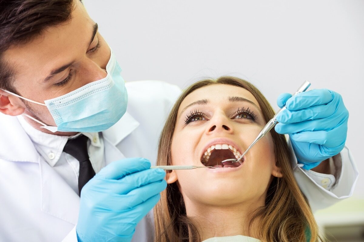 Dentist examining patient's teeth during dental checkup in Lake Ridge.